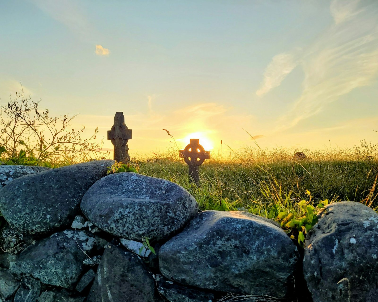 Peaceful memorial crosses at sunset